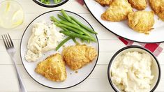 three plates with chicken, mashed potatoes and green beans