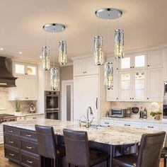 a kitchen with marble counter tops and an island in front of the stove top oven