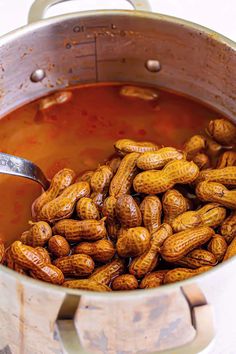 a pot full of peanuts sitting on top of a table