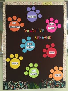 a bulletin board with colorful paw prints on it's black background that says pawstivee behavior help others