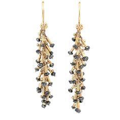 "Long Diamond Earrings 14k Yellow Gold Size 2\" Black Diamond Cluster Dangle Earrings Fancy Linear Earrings Handmade Bridal Jewelry We started making these black diamond cluster earrings by granulating small balls of yellow gold and soldering each in groups of ones and twos to solid 14k yellow gold heishi beads. Each heishi bead was then strung through gold wire with a single black diamond bead and wrapped onto a gold cable chain forming a delightful cluster of kinetic sparkle. The facets on the diamond beads catch the light and make these earrings seem to dance on the ear with the movement of its wearer. They have a fancy bold feminine look that's versatile enough for office, ballroom or wedding. Style: 21st Century Diamond Cluster Earrings Weight: 4.5 dwt Stone: Approximately 2.5mm round Formal Long Drop Earrings With Dangling Beads, Formal Long Drop Dangling Beads Earrings, Diamond Cut Dangle Earrings, Yellow Gold Long Drop Earrings With Dangling Beads, Diamond Cut Dangle Chandelier Earrings, Gold Briolette Earrings With Dangling Beads, Yellow Gold Dangle Chandelier Earrings For Celebration, Yellow Gold Chandelier Dangle Earrings For Celebration, Long Diamond Earrings