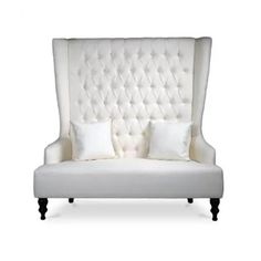 a white couch with two pillows on it