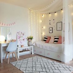 a bedroom with white walls and lights on the ceiling