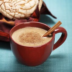 two cups of hot chocolate with cinnamon sticks in them