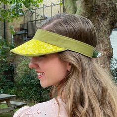 Boo That have reimagined the sun visor into fashionable, luxurious statement headwear. They are lightweight and soft to wear and to handle.  Visors are made one at a time, by hand, in my London millinery studio in a range of carefully curated fabrics.  Size Medium fits approximately 53-59cm head size. Chartreuse yellow graphic print with contrast sage green linen. They were developed originally for a customer who wanted something prettier than a sports visor to protect her skin when she was havi Summer Visor Sun Hat With Upf 50+, Summer Sun Visor Hat With Upf 50+, Summer Sun Hat With Upf 50+ Visor, Upf 50+ Sun Visor Hat For Summer, Summer Sun Hat With Uv Protection Visor, Summer Visor Sun Hat, Green Visor Sun Hat With Uv Protection, Trendy Summer Visor Sun Hat, Spring Visor Sun Hat With Uv Protection