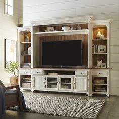 a living room with a large entertainment center