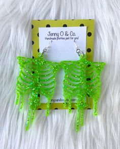 "You pick your glitter color LARGE skeleton earrings! Earrings hang from .925 solid sterling silver ear wires made in the USA. Size is approximately: 3.75\" Long and 1.75\" wide. See the glow in the dark style here: https://www.etsy.com/listing/864370661/glow-in-the-dark-skeleton-earrings-glow?ref=shop_home_active_1 I ship all earrings on various cardstock designs in 3 1/2\" x 3 1/2\" eco friendly reusable high quality jewelry boxes made in the US. I package up to 2 pairs in each box and tie eac Glitter Skeleton, Dark Skeleton, Candy Corn Earrings, Laser Projects, Skeleton Earrings, Dark Style, Earrings Halloween, Jewellery Box Making, Costume Earrings