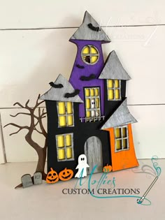 a paper house with halloween decorations on it