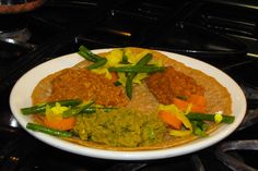 a white plate topped with food on top of a stove