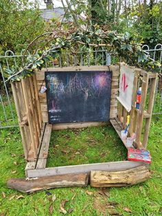 a small garden with a chalkboard in the middle