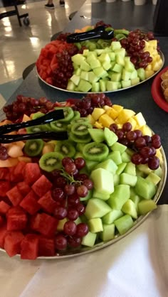 two platters filled with different types of fruit