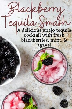 two glasses filled with blackberries and ice on top of a white counter next to a bowl