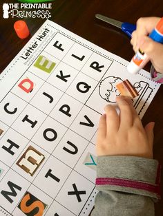 a young child is doing an activity with letters and numbers to help them learn the alphabet