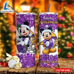 two tumblers with mickey and minnie on them sitting next to each other in front of a christmas tree