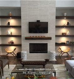 a living room filled with furniture and a flat screen tv mounted on the wall above a fireplace