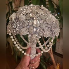 a person holding a bouquet made out of pearls