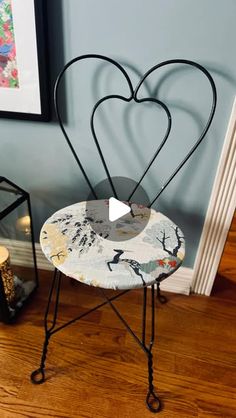 a heart shaped chair sitting on top of a hard wood floor next to a wall