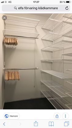 an empty closet with shelves and clothes hanging on the wall next to it is shown