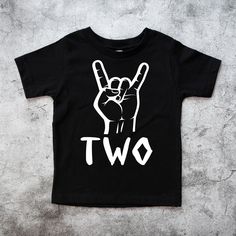 a black t - shirt with the word two written in white on it and a peace sign