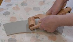 a person using a knife to cut wood