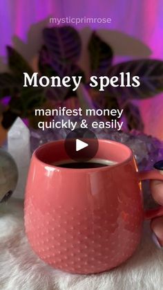 a woman holding a pink mug with money spells on the side and text reading, manifest money quickly & easily