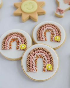 three decorated cookies sitting on top of a table