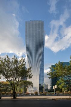 a very tall building sitting next to some trees