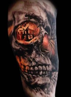 a man's arm with a skull and an eye tattoo on the upper half of his arm