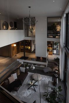 a living room filled with lots of furniture and a chandelier hanging from the ceiling