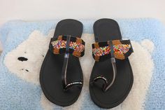 Unique Gift | Sandals | Gladiator Sandals | Greek Sandals | Beach Jewelry | Wedding Shoes | Leather Sandals | Custom | Mothers GiftAn elegant and authentic pair of African inspired beaded ladies sandals, with a unique and eye-catching design. 100% genuine leather. *100% genuine leather.Main Color - Multicolored. ✂⋯⋯ S I Z E  C H A R T ⋯⋯✂EU.........USA........UK.........CM............INCHES34..........3.5...........1.5.........22.3...........8.835..........4.5...........2.5........23............ Traditional Adjustable Toe Post Sandals, Handmade Artisan Sandals With Round Toe, Traditional Sandals With Adjustable Single Toe Strap, Traditional Handmade T-strap Sandals For Festival, Handmade Bohemian Open Toe Slippers, Bohemian Handmade Open Toe Slippers, Traditional Adjustable Slip-on Sandals, Traditional Black Sandals For The Beach, Traditional Toe Post Flip Flops For Festival