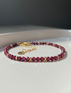 Immerse yourself in the luxury of our handcrafted bracelet with faceted garnet beads and elegant 18k gold spacer beads. Each individual pearl shines with a sparkling shine that is particularly effective in the sunlight. The bracelet fastens with an 18k gold clasp for a royal touch. The natural garnet beads are not only beautiful but also have numerous benefits. They promote vitality, passion and endurance. Let yourself be enchanted by this handmade piece of jewelry made with love. An exquisite a Gold Pendant Jewelry, Garnet Bracelet, Handcrafted Bracelets, Garnet Jewelry, Faceted Bead, Gemstone Bracelet, Spacer Beads, Quality Jewelry, Beautiful Bracelet