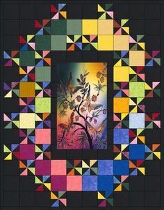 a colorful quilt with an image of a tree in the center