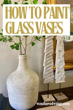 a white vase sitting on top of a wooden table next to a mirror and potted plant