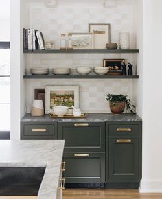 the kitchen is clean and ready to be used for cooking or baking, with open shelving on the wall