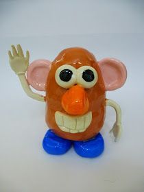 a plastic toy with an orange nose and big eyes