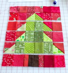 a piece of quilted material is being sewn together to make a christmas tree ornament