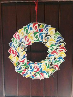 a wreath made out of playing cards hanging from a door frame with the number nine on it