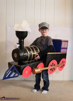 a young boy is dressed up as a train