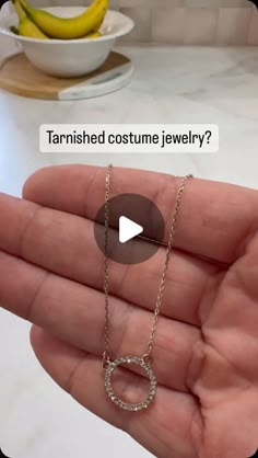 a person holding a necklace in their hand with the caption tarnished costume jewelry?