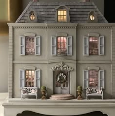 a doll house with furniture and lights on the front door is shown in this image