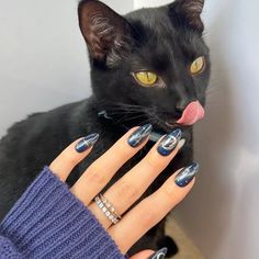 This midnight-toned cat-eye mani is a work of art. The navy-to-silver shimmer shift and metallic silver nail art create a mystical Halloween nail look we'd recreate in a heartbeat. Almond Tips, Halloween Nails Designs, Mystical Halloween, Burgundy Nail Polish, Halloween Nail Ideas, Silver Nail Art, Spooky Fall, Fall Manicure