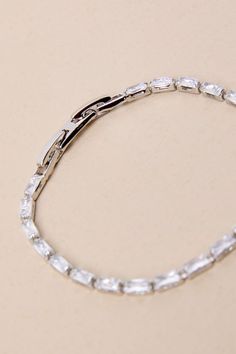 All your most important looks will shine when you add a little glamour, thanks to the Lulus Sparkling Essential Silver Rhinestone Bracelet! Shiny, silver-toned metal shapes this elevated, minimalist-chic bracelet that has a slender silhouette with inset baguette-cut rhinestones that create a tennis bracelet-inspired design. Clasp closure. Bracelet measures 5. 5" long, with . 5" adjustment on each side. Man Made Materials. Imported. Lulus | Sparkling Essential Silver Rhinestone Bracelet. Classic Silver Crystal Bracelet, Modern Silver Bracelets With Sparkling Stones, Elegant Silver Chain Bracelet With Sparkling Stones, Chic Silver Chain Bracelet For Formal Occasions, Modern Silver Crystal Bracelet For Formal Occasions, Glamorous Silver Crystal Bracelet, Minimalist Silver Tennis Bracelet For Wedding, Chic Silver Bracelets For Wedding, Elegant Metal Crystal Bracelet