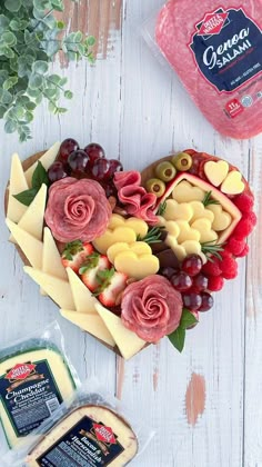 a heart shaped platter with cheese, meat and fruit