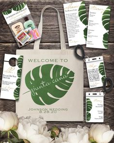 an image of a welcome sign and wedding stationery with flowers on the table next to it