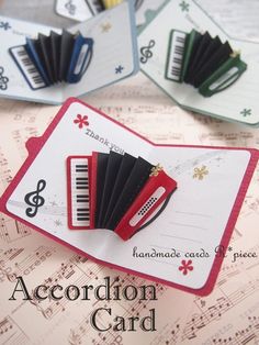 an accordion card with music notes and musical notes on the front, sitting next to each other