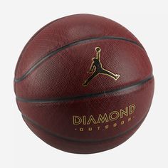 a basketball with the jordan logo is shown in front of a white background and has gold lettering on it