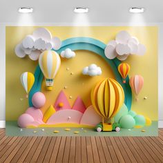 an empty room with balloons and clouds on the wall, in front of a wooden floor