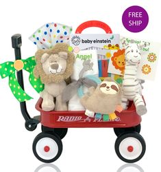 a red wagon filled with stuffed animals and books sitting on top of a white floor