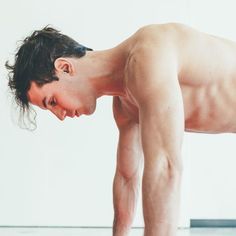 a shirtless man is doing push ups on the floor