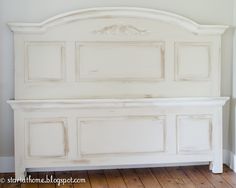 an old white headboard is sitting on the floor